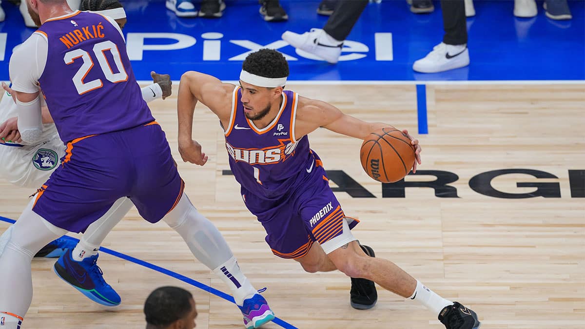 Phoenix Suns guard Devin Booker (1) dribbles against the Minnesota Timberwolves in the first quarter during game two of the first round for the 2024 NBA playoffs at Target Center