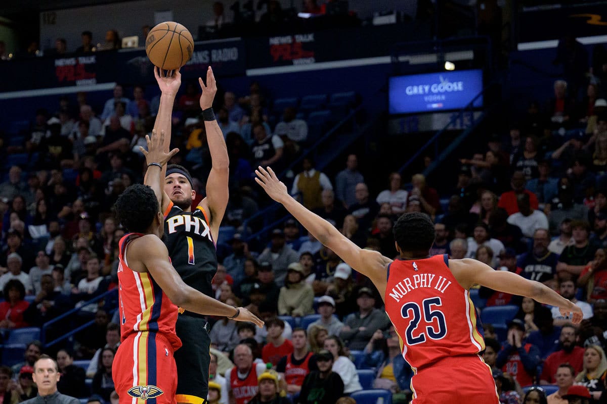 Phoenix Suns guard Bradley Beal (3) shoots a three point basket against New Orleans Pelicans forward Herbert Jones (5) and New Orleans Pelicans guard Trey Murphy III (25) during the first half at Smoothie King Center