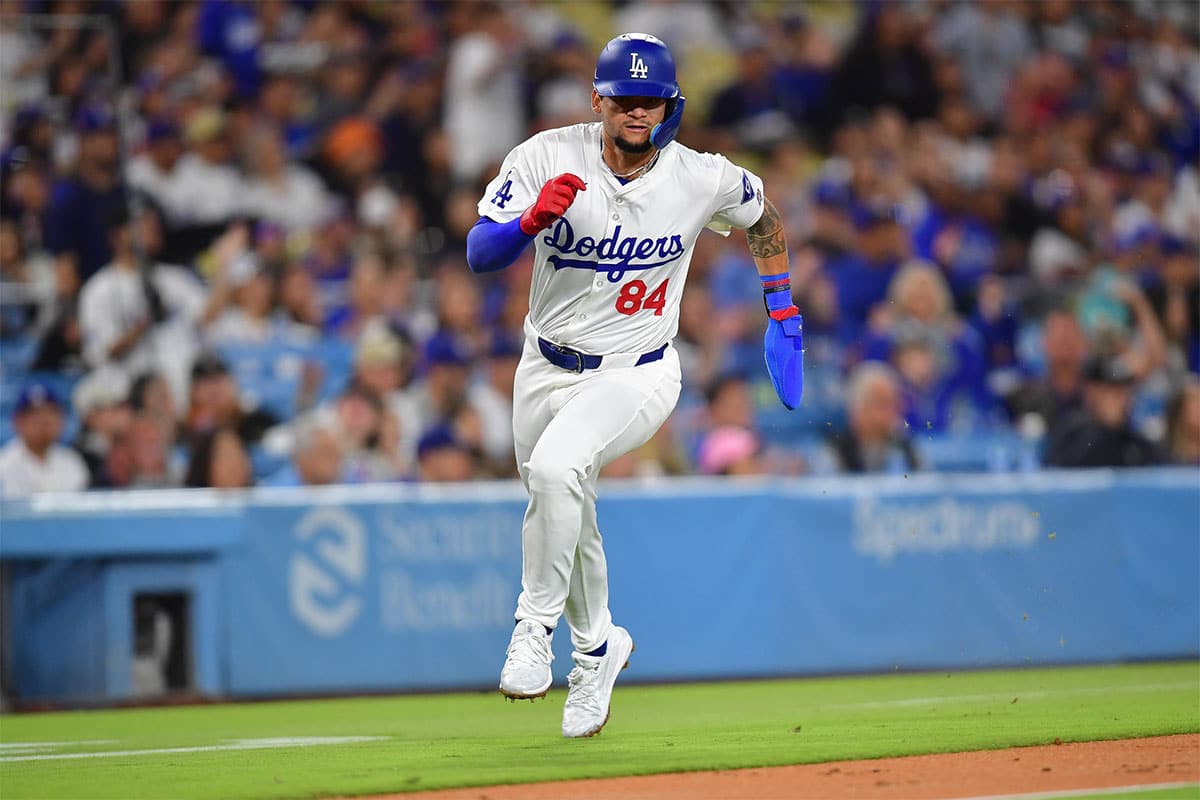  Los Angeles Dodgers center fielder Andy Pages (84) scores a run during his major league debut against the Washington Nationals during the second inning at Dodger Stadium.