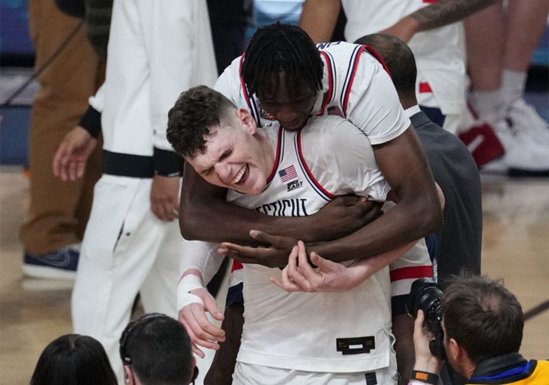 Donovan Clingan and Youssouf Singare celebrating during the Final Four