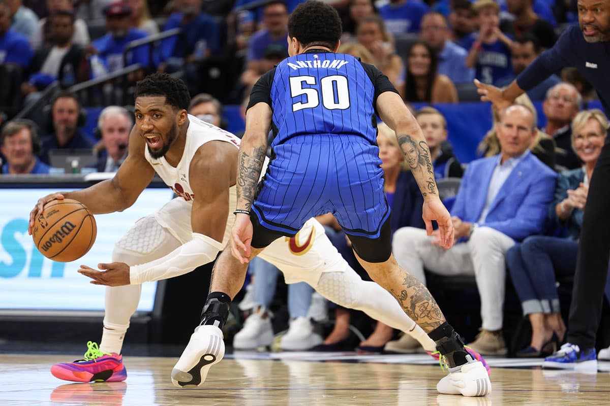 Orlando Magic guard Cole Anthony (50) guards Cleveland Cavaliers guard Donovan Mitchell (45) 