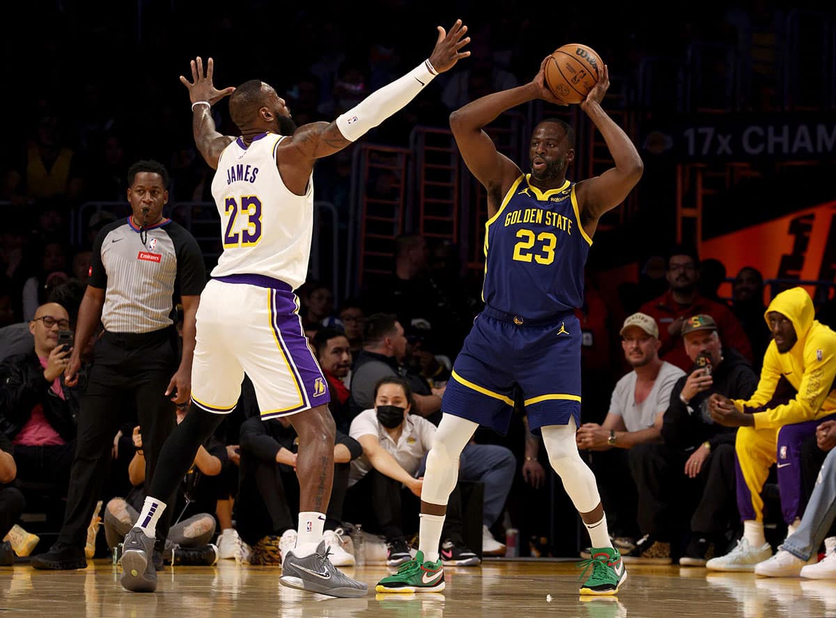 Golden State Warriors forward Draymond Green (23) looks to pass against Los Angeles Lakers forward LeBron James (23) during the first quarter at Crypto.com Arena. 