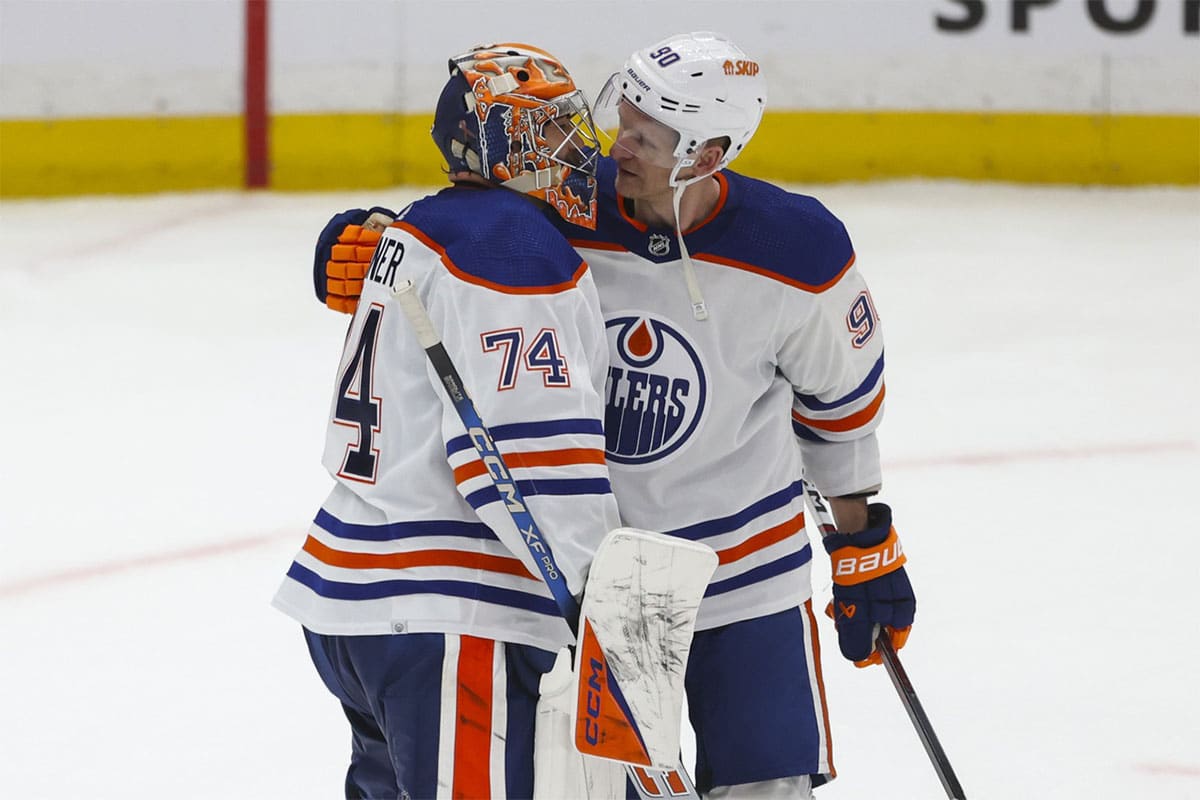  Edmonton Oilers goalie Stuart Skinner (74) and Edmonton Oilers right wing Corey Perry (90) embrace after defeating the Los Angeles Kings in the third period of game four of the first round of the 2024 Stanley Cup Playoffs at Crypto.com Arena. 