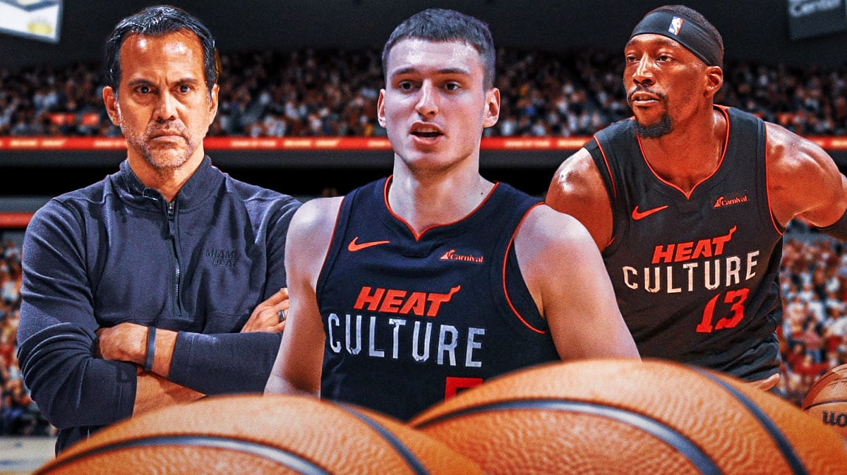 Miami Heat star Nikola Jovic in the middle of Erik Spoelstra and Bam Adebayo in front of the Kaseya Center.