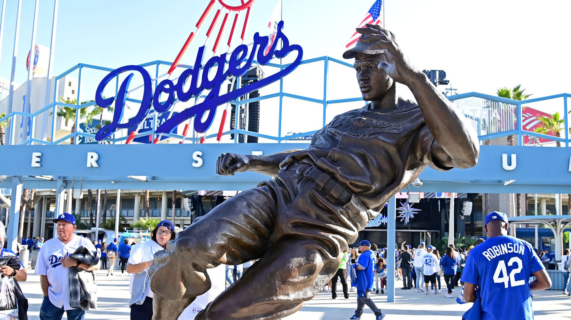 Fans take photos at the Jackie Robinson statue as they attend the game between the Los Angeles Dodgers and the Cincinnati Reds to celebrate the 75th anniversary of Jackie Robinson breaking the color barrier in Major League Baseball at Dodger Stadium.