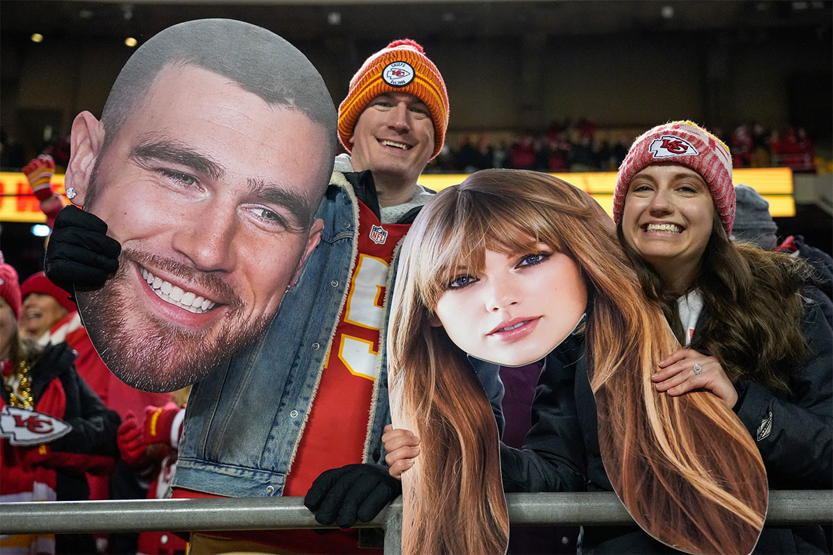 Fans wave big heads of Travis Kelce and Taylor Swift during the Kansas City Chiefs' game against the Cincinnati Bengals at Arrowhead Stadium.