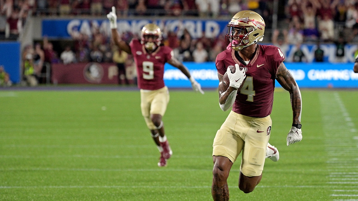 Florida State Seminoles wide receiver Keon Coleman (4) runs the ball for a touchdown during the first half against the Louisiana State Tigers at Camping World Stadium. 