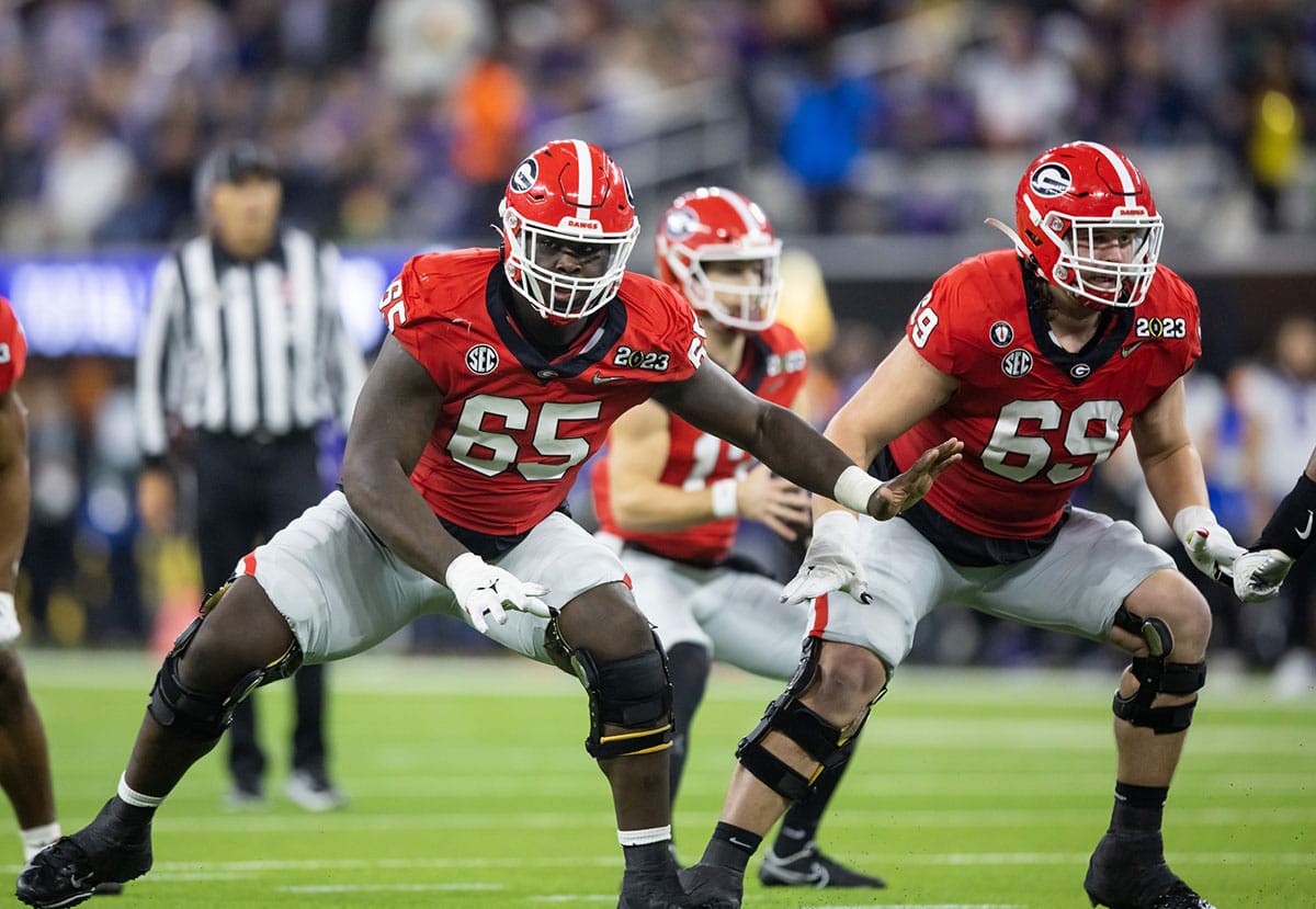 Georgia Bulldogs offensive lineman Amarius Mims (65) and offensive lineman Tate Ratledge (69) against the TCU Horned Frogs during the CFP national championship game at SoFi Stadium. 
