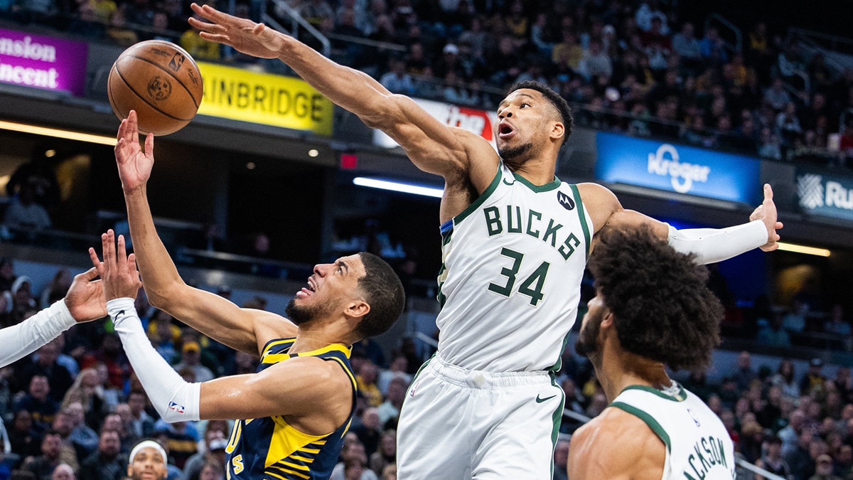  Indiana Pacers guard Tyrese Haliburton (0) shoots the ball while Milwaukee Bucks forward Giannis Antetokounmpo (34) defends in the second half at Gainbridge Fieldhouse.