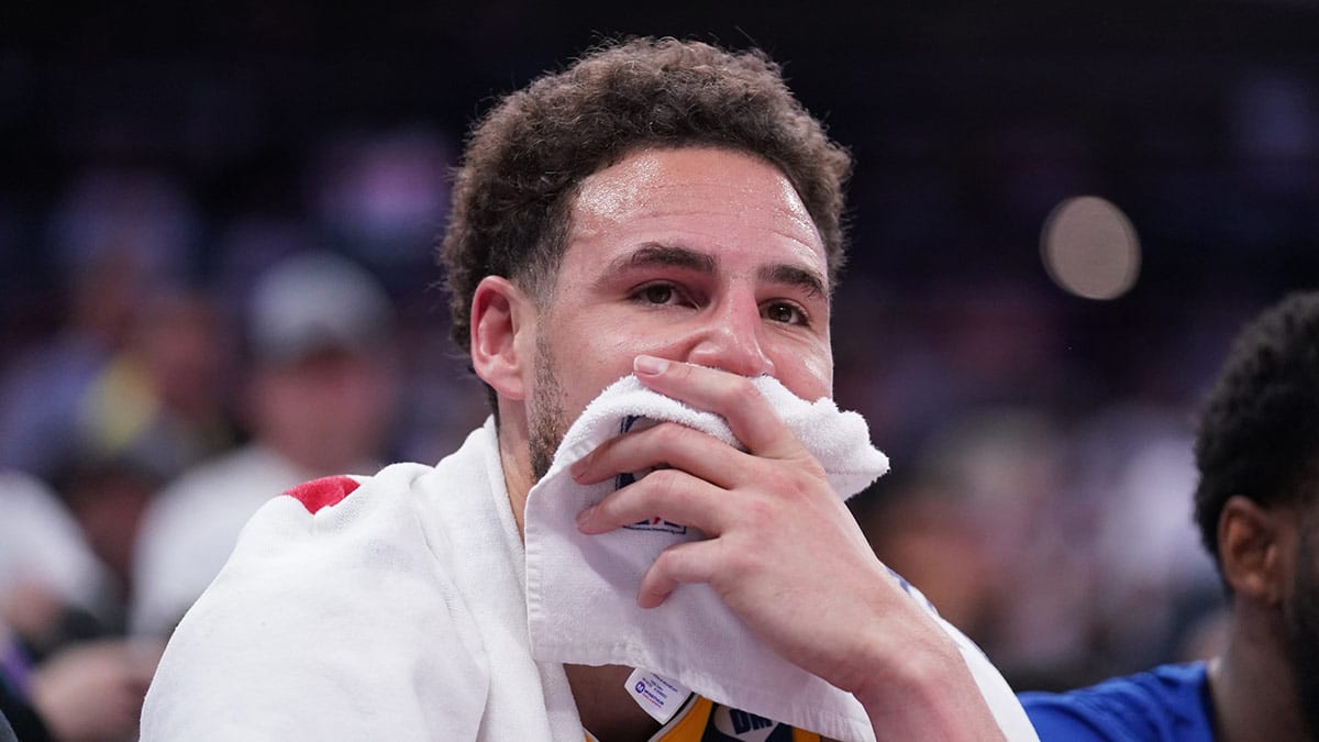 Golden State Warriors guard Klay Thompson (11) sits on the bench during action against the Sacramento Kings in the fourth quarter during a play-in game of the 2024 NBA playoffs at the Golden 1 Center.