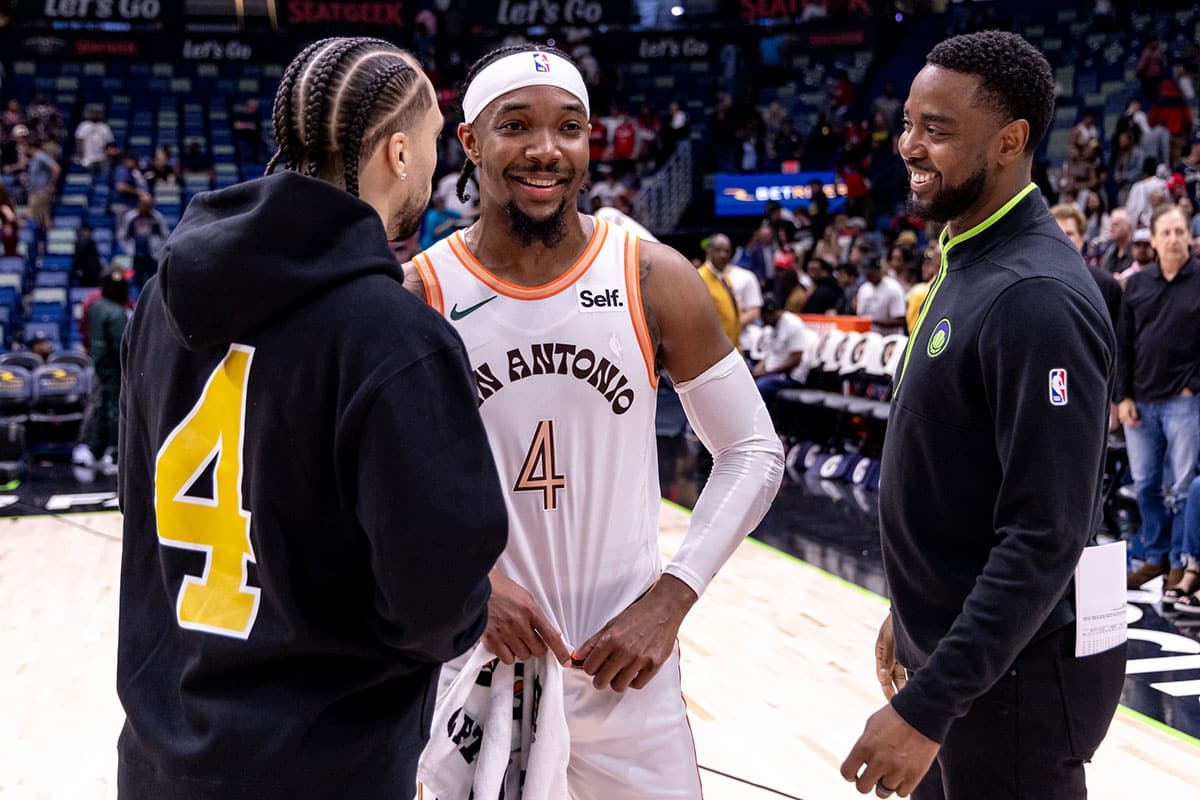 San Antonio Spurs guard Devonte' Graham (4) shares a laugh with New Orleans Pelicans guard Jose Alvarado (15) after the game at Smoothie King Center.