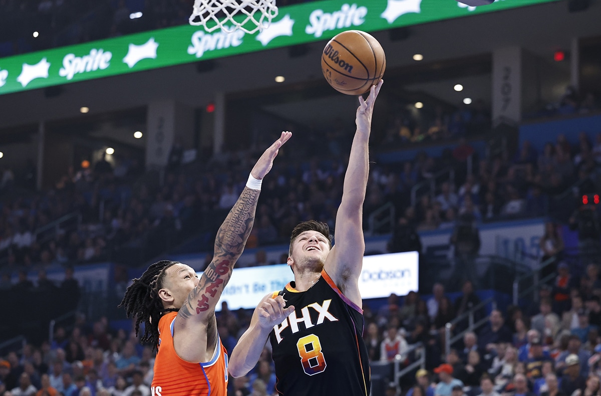 Phoenix Suns guard Grayson Allen (8) goes up for a basket as Oklahoma City Thunder forward Jaylin Williams (6) defends during the first half at Paycom Center