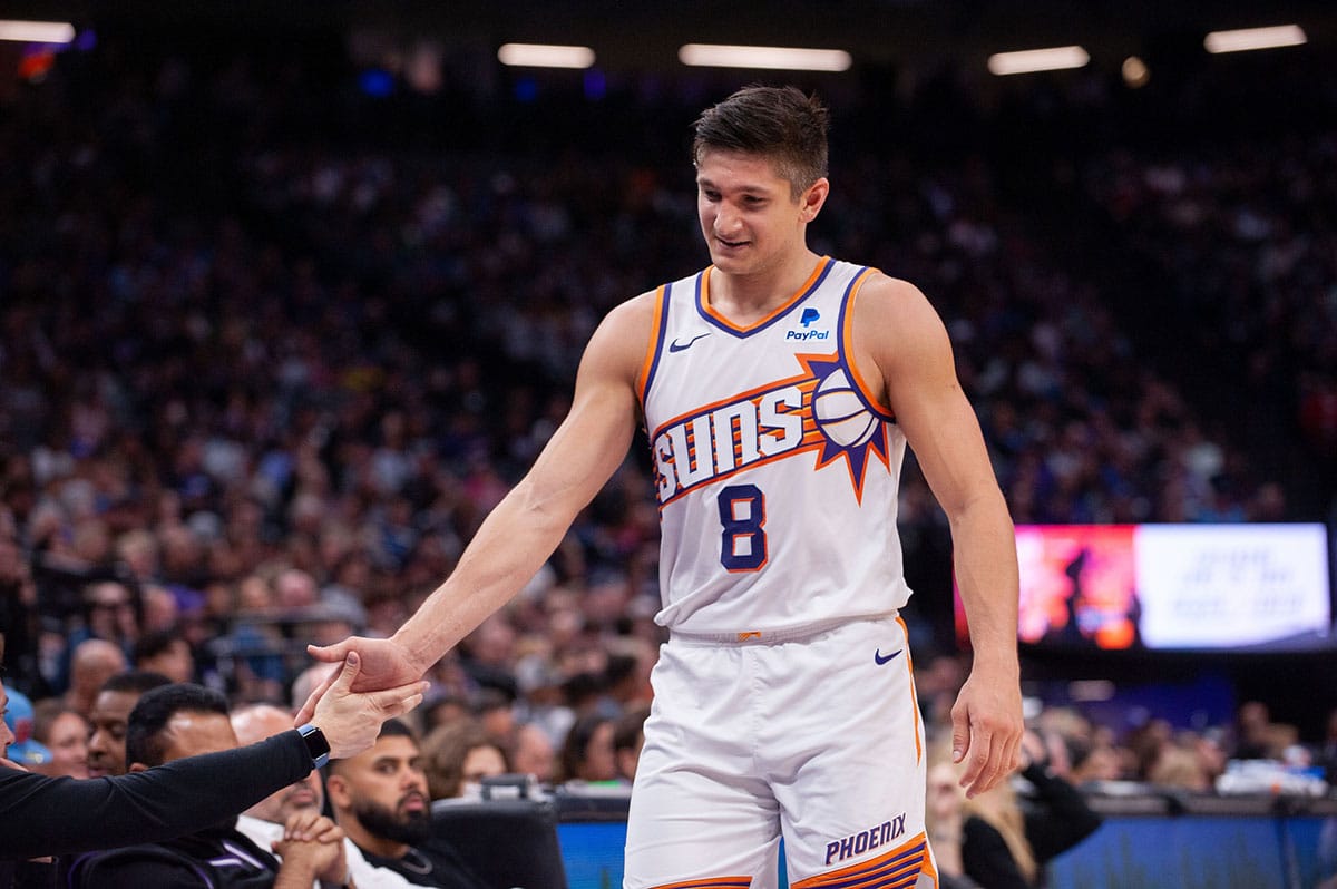Phoenix Suns guard Grayson Allen (8) high fives coaches as he comes out of the game during the second quarter at Golden 1 Center.