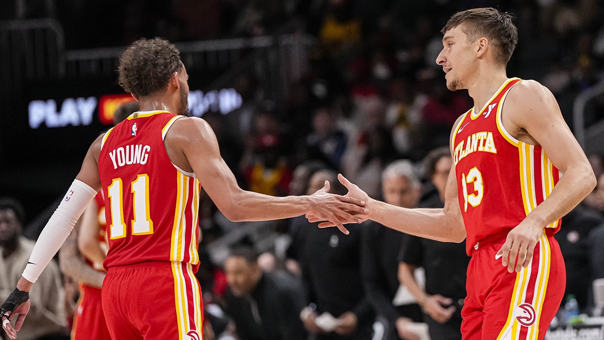  Atlanta Hawks guard Trae Young (11) and guard Bogdan Bogdanovic (13) react during the game against the Charlotte Hornets during the second half at State Farm Arena.