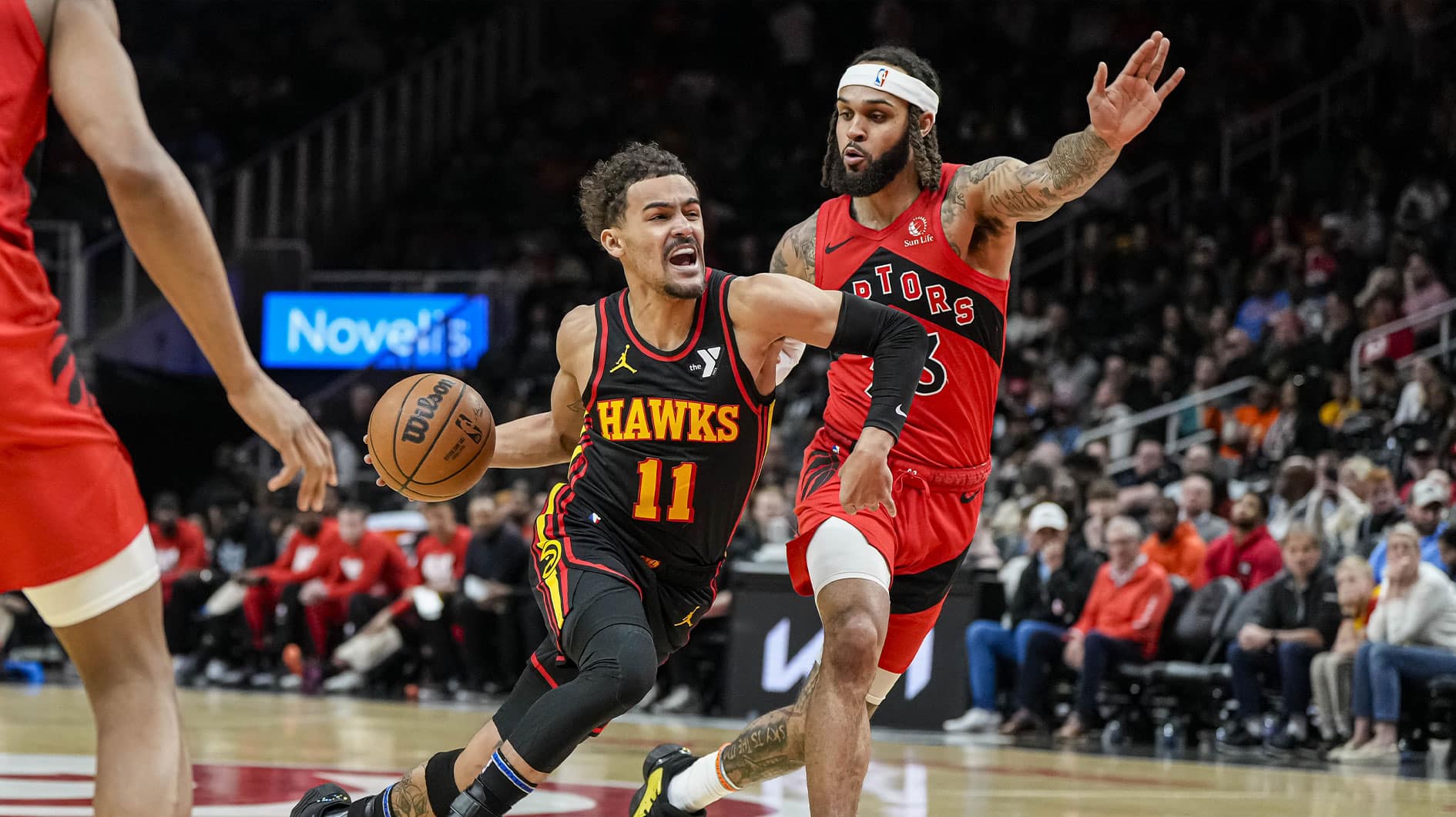 Atlanta Hawks guard Trae Young (11) dribbles guarded by Toronto Raptors guard Gary Trent Jr. (33) during the first half at State Farm Arena. 