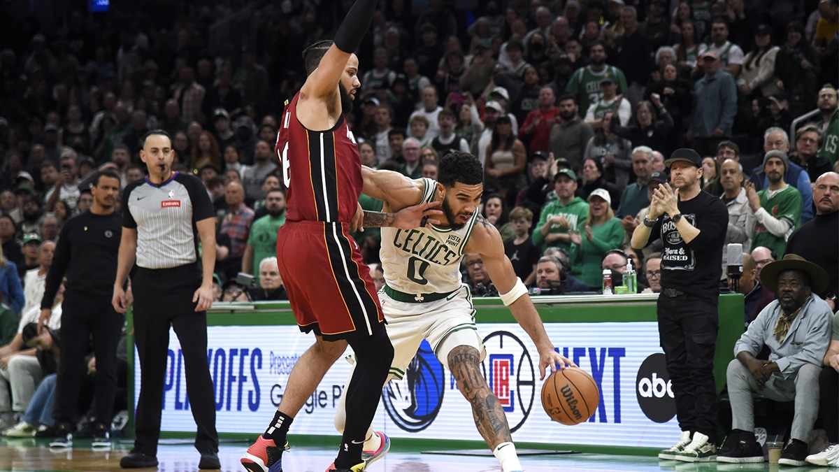 Boston Celtics forward Jayson Tatum (0) controls the ball while Miami Heat forward Caleb Martin (16) defends during the second half in game one of the first round for the 2024 NBA playoffs at TD Garden.