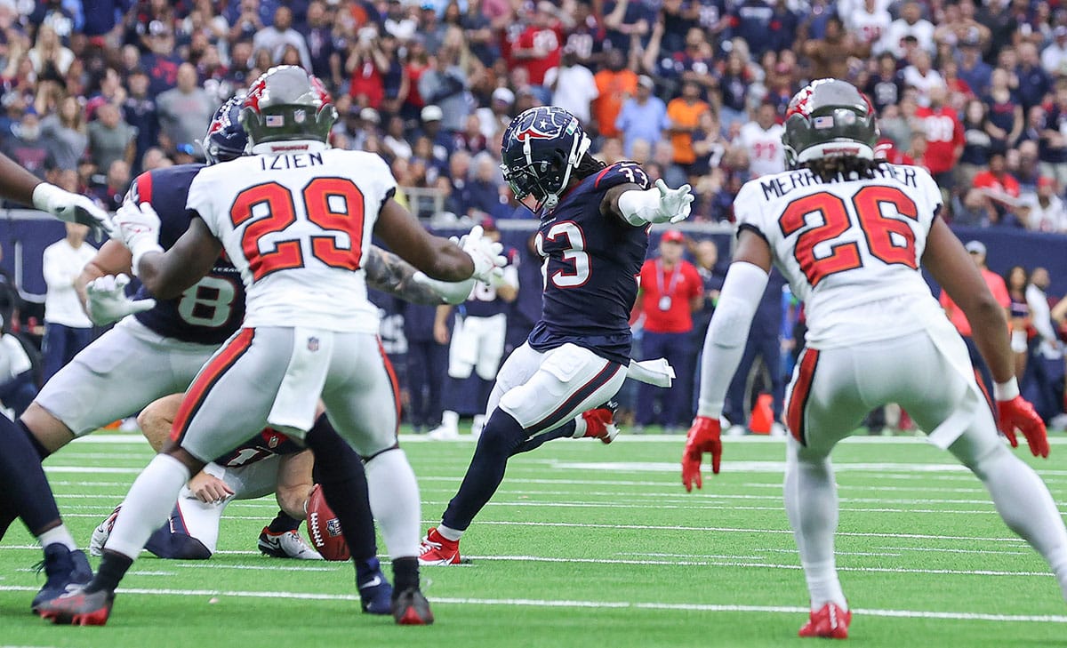 Houston Texans running back Dare Ogunbowale (33) kicks a field goal during the fourth quarter against the Tampa Bay Buccaneers at NRG Stadium.