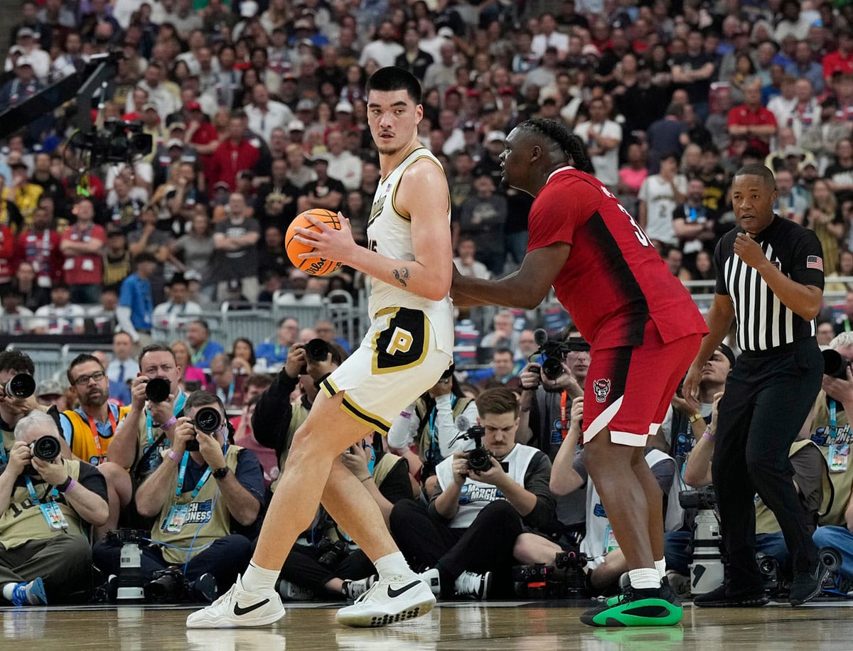 Purdue center Zach Edey (15) is defended by North Carolina State forward DJ Burns Jr. (30) during the Final Four semifinal game at State Farm Stadium.