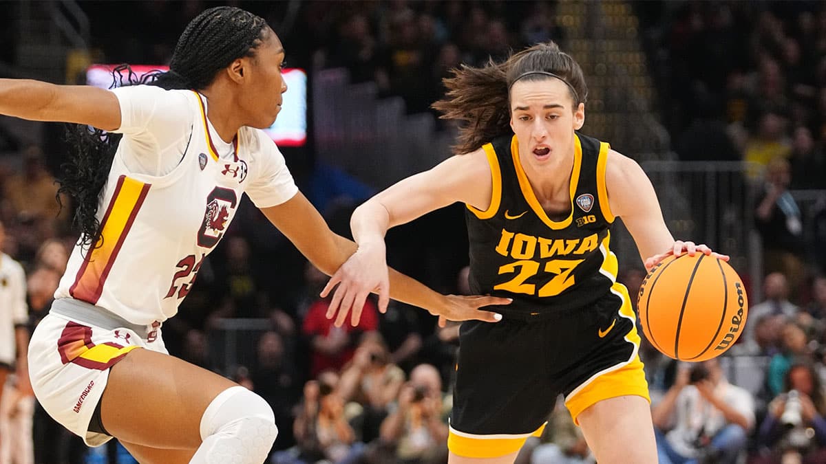 Iowa Hawkeyes guard Caitlin Clark (22) drives to the basket as South Carolina Gamecocks guard Bree Hall (23) defends during the NCAA Tournament championship basketball game at Rocket Mortgage Fieldhouse,