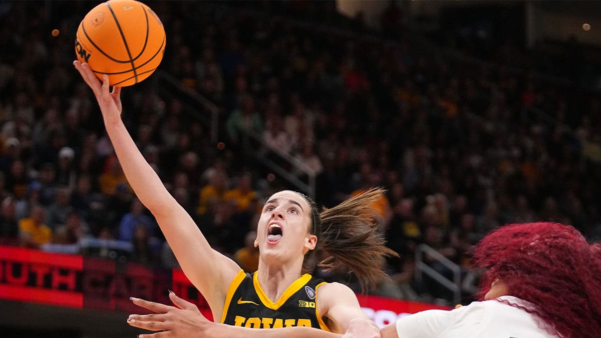 Iowa Hawkeyes guard Caitlin Clark (22) drives to the basket as South Carolina Gamecocks center Kamilla Cardoso (10) defends during the NCAA Tournament championship basketball game at Rocket Mortgage Fieldhouse,
