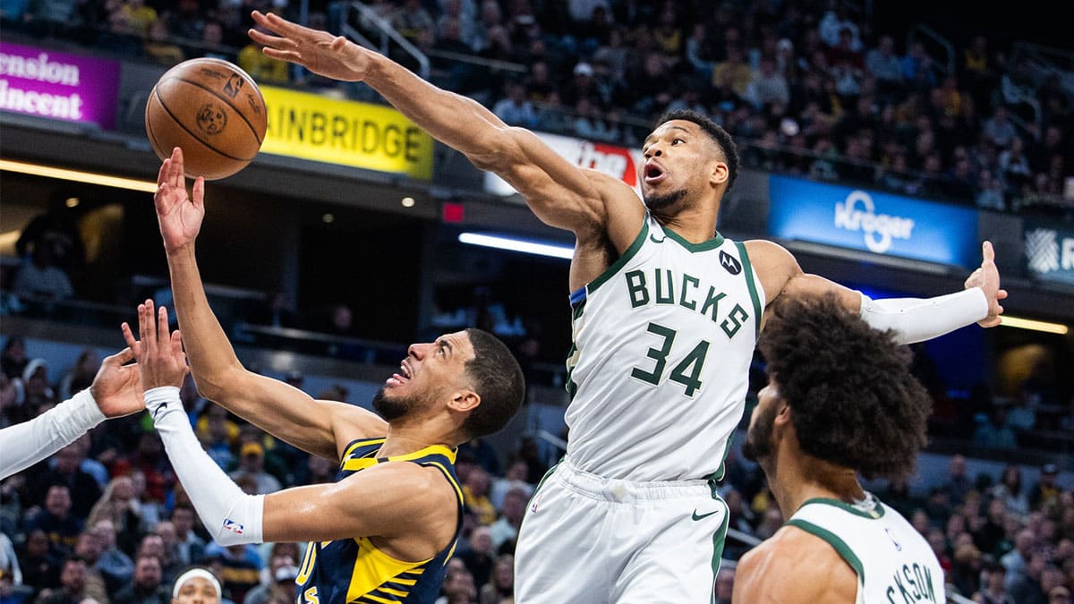 Indiana Pacers guard Tyrese Haliburton (0) shoots the ball while Milwaukee Bucks forward Giannis Antetokounmpo (34) defends in the second half at Gainbridge Fieldhouse.