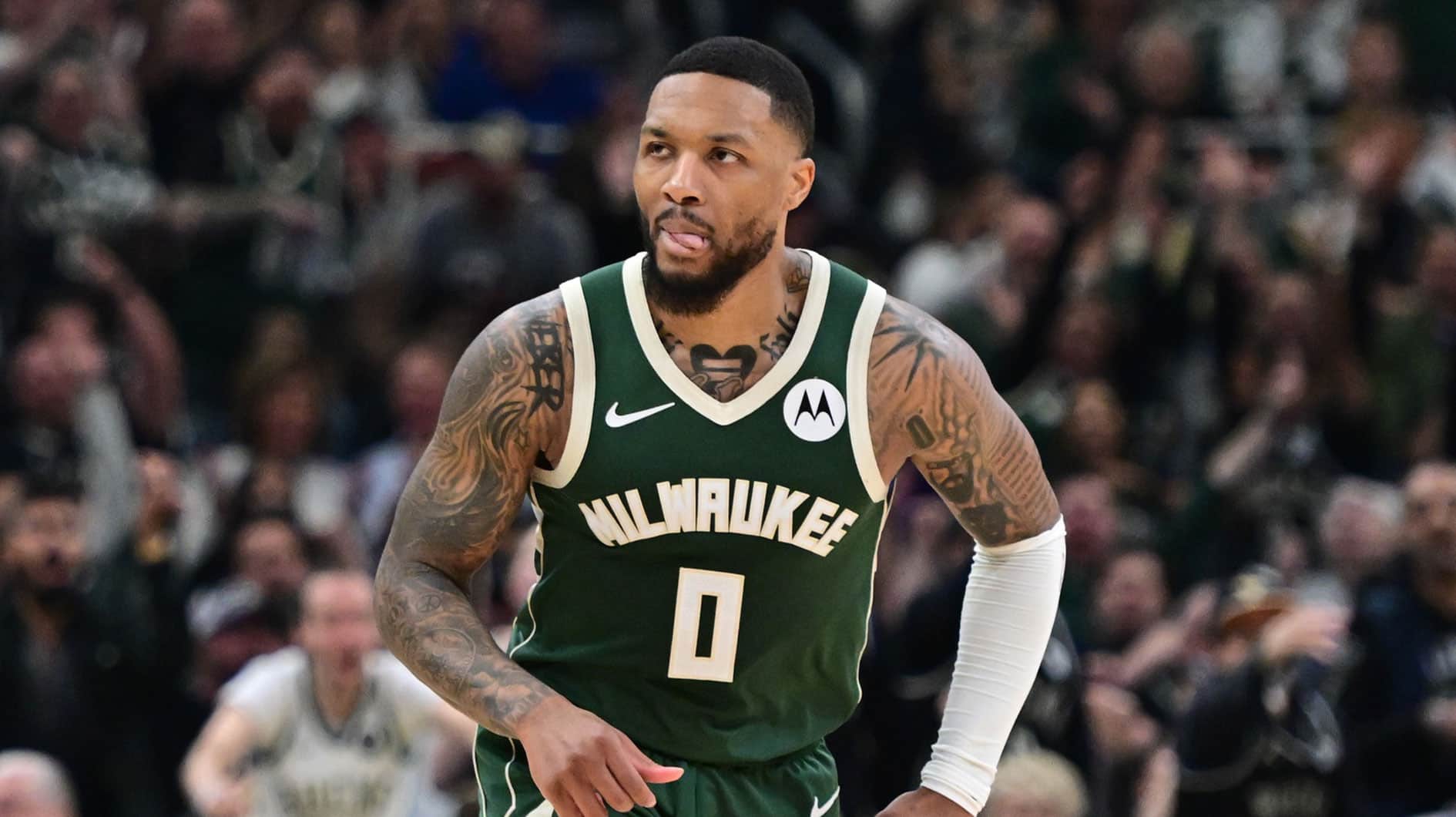 Milwaukee Bucks guard Damian Lillard (0) reacts after scoring a basket in the in the second quarter against the Indiana Pacers during game one of the first round for the 2024 NBA playoffs at Fiserv Forum.