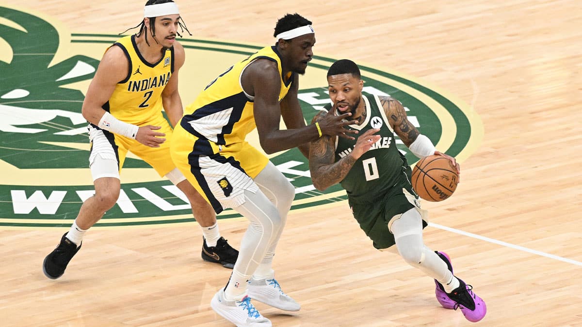 Milwaukee Bucks guard Damian Lillard (0) dribbles past Indiana Pacers forward Pascal Siakam (43) in the first half during game two of the first round for the 2024 NBA playoffs at Fiserv Forum.