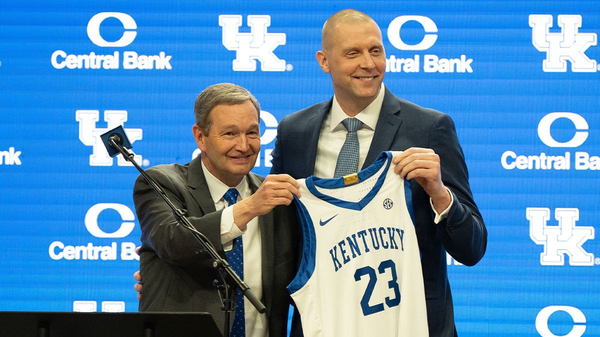 University of Kentucky Athletic Director Mitch Barnhart and new men’s basketball coach Mark Pope hold a new basketball jersey up during Pope’s press conference on Sunday, April 14, 2024.