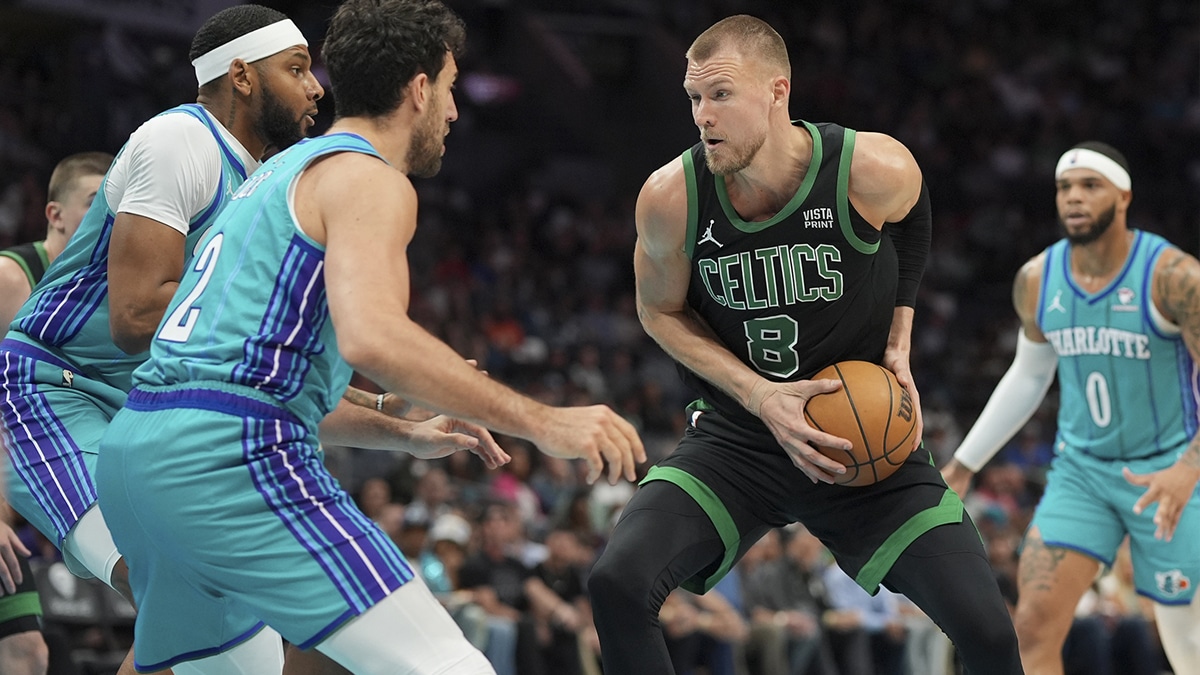 Boston Celtics center Kristaps Porzingis (8) handles the ball against Charlotte Hornets guard Vasilije Micic (22) during the first quarter at Spectrum Center.