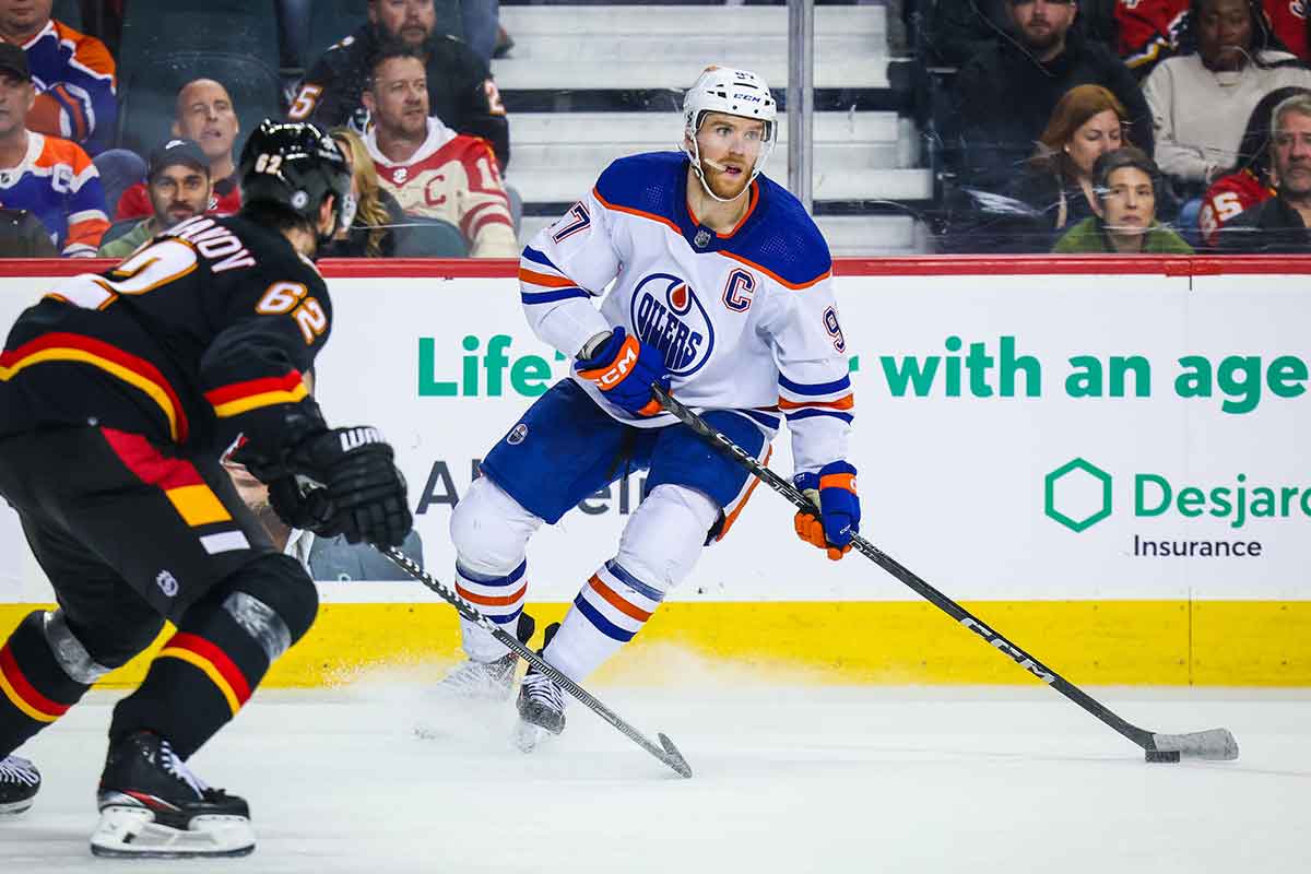 Edmonton Oilers center Connor McDavid (97) controls the puck against the Calgary Flames during the third period at Scotiabank Saddledome.