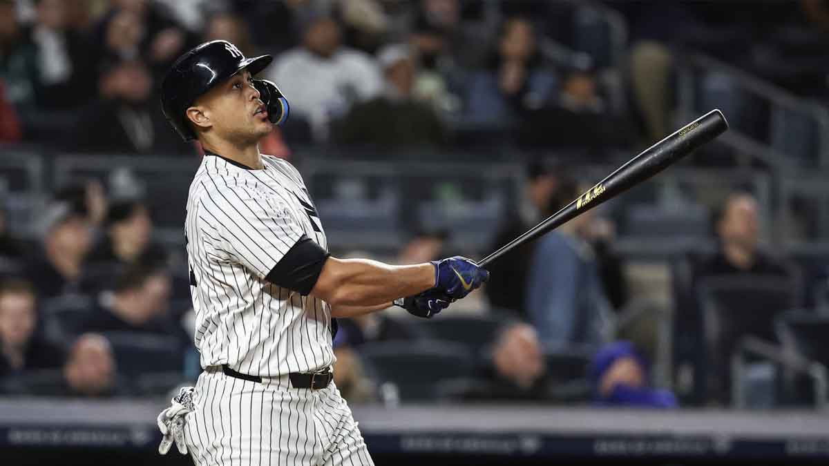  New York Yankees designated hitter Giancarlo Stanton (27) hits a solo home run in the sixth inning against the Miami Marlins at Yankee Stadium.