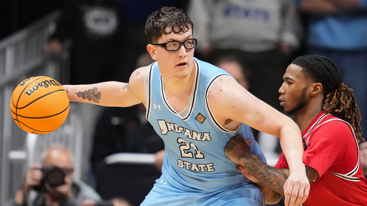 Indiana State Sycamores center Robbie Avila (21) goes in for a lay-up against Utah Utes guard Deivon Smith (5) on Tuesday, April 2, 2024, during the NIT semifinals at Hinkle Fieldhouse in Indianapolis. The Indiana State Sycamores defeated the Utah Utes, 100-90.