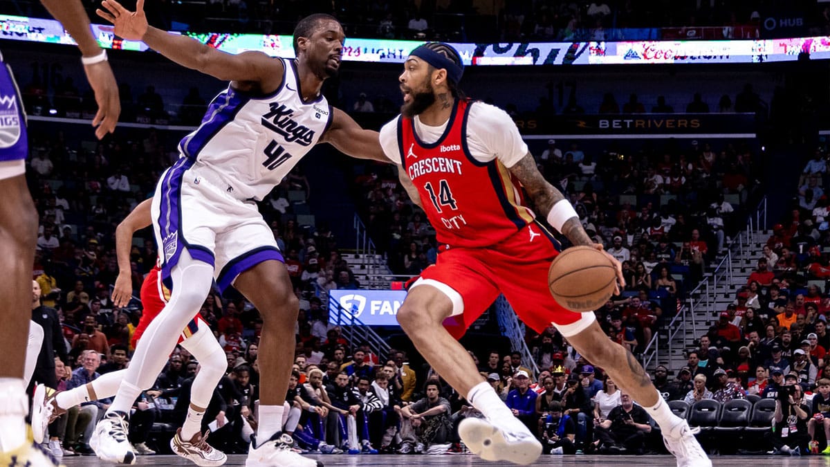  New Orleans Pelicans forward Brandon Ingram (14) dribbles against Sacramento Kings forward Harrison Barnes (40) in the first half during a play-in game of the 2024 NBA playoffs at Smoothie King Center.