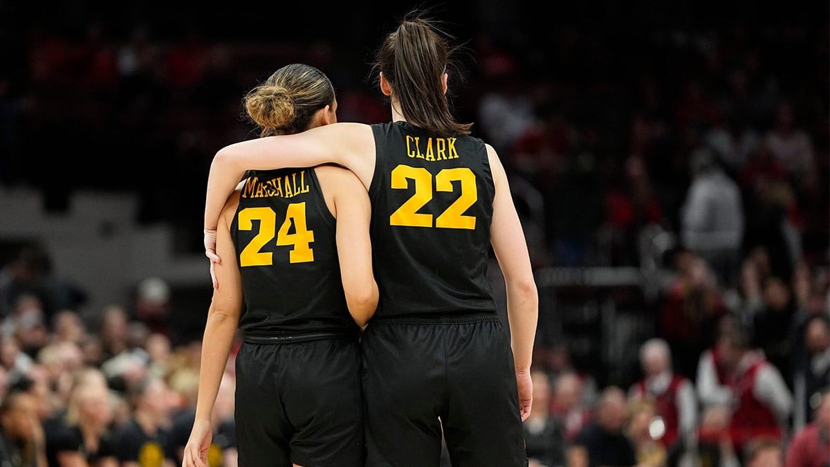 Iowa Hawkeyes guard Caitlin Clark (22) puts her arm around guard Gabbie Marshall (24) din the final seconds of the second half of the NCAA women's basketball game against the Ohio State Buckeyes at Value City Arena.