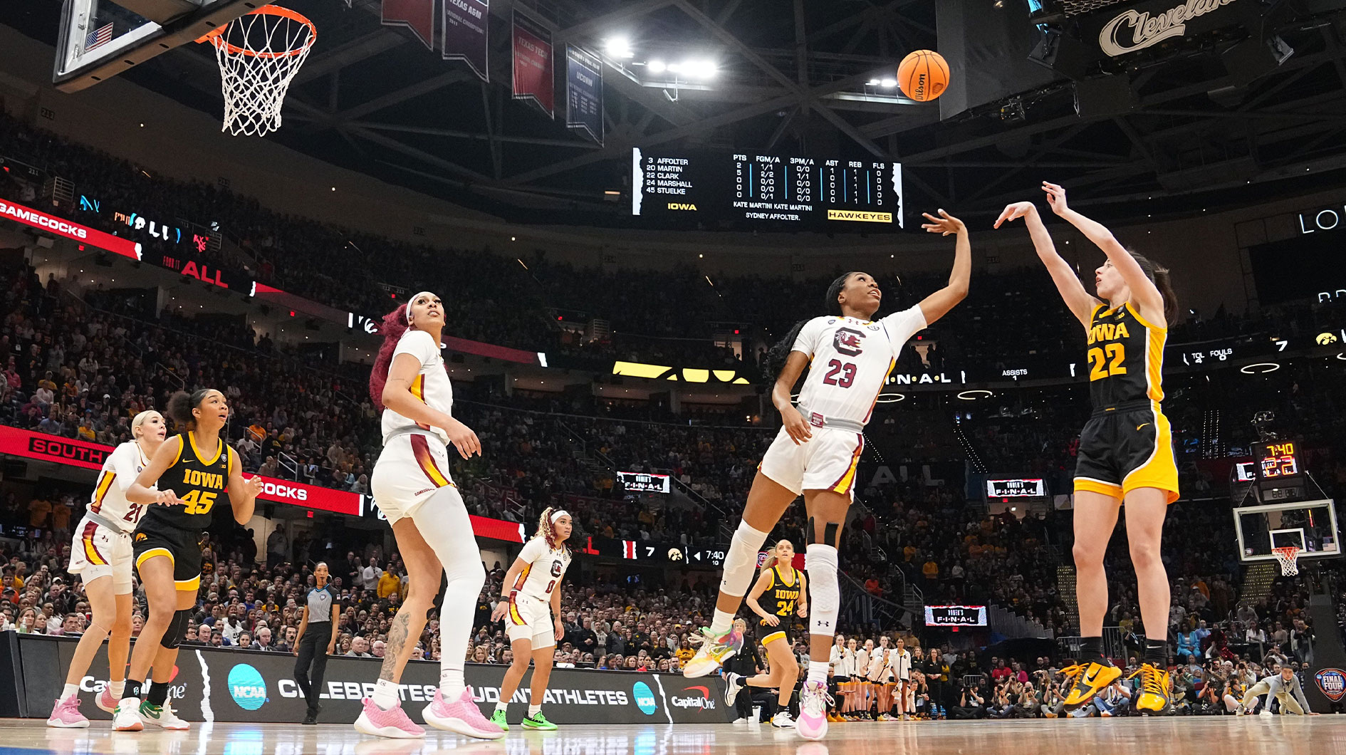 Iowa Hawkeyes guard Caitlin Clark (22) shoots the ball as South Carolina Gamecocks guard Bree Hall (23) defends during the NCAA Tournament championship basketball game at Rocket Mortgage Fieldhouse, Sunday, April 7, 2024 in Cleveland.