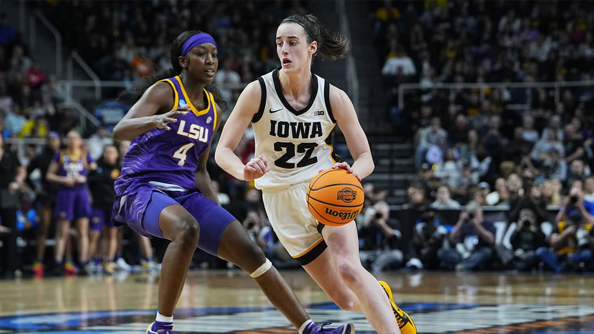 Iowa Hawkeyes guard Caitlin Clark (22) controls the ball against LSU Lady Tigers guard Flau'jae Johnson (4) in the fourth quarter in the finals of the Albany Regional in the 2024 NCAA Tournament at MVP Arena.