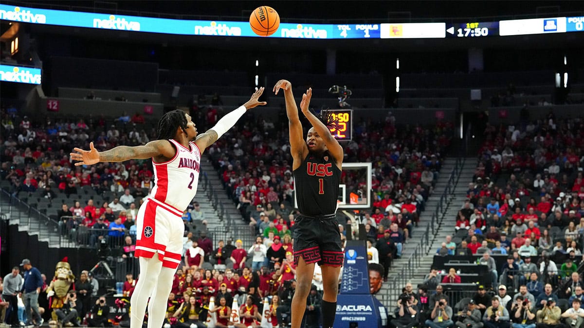 Mar 14, 2024; Las Vegas, NV, USA; Southern California Trojans guard Isaiah Collier (1) shoots against Arizona Wildcats guard Caleb Love (2) during the first half at T-Mobile Arena.