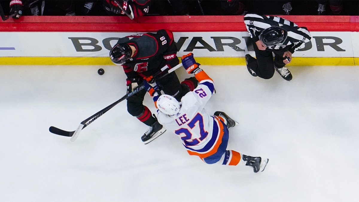 Carolina Hurricanes center Martin Necas (88) is checked by New York Islanders left wing Anders Lee (27) during the third period in game one of the first round of the 2024 Stanley Cup Playoffs at PNC Arena.