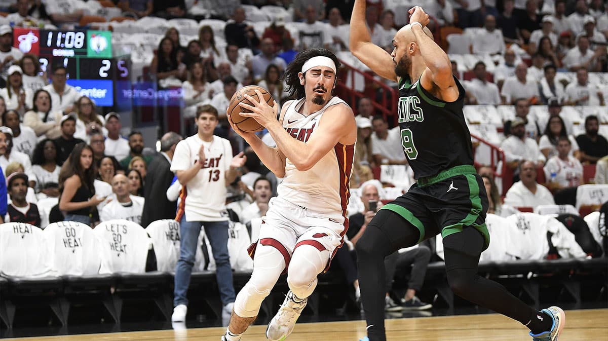 Miami Heat guard Jaime Jaquez Jr. (11) drives on Boston Celtics guard Derrick White (9) during the first quarter of game four of the first round for the 2024 NBA playoffs at Kaseya Center.