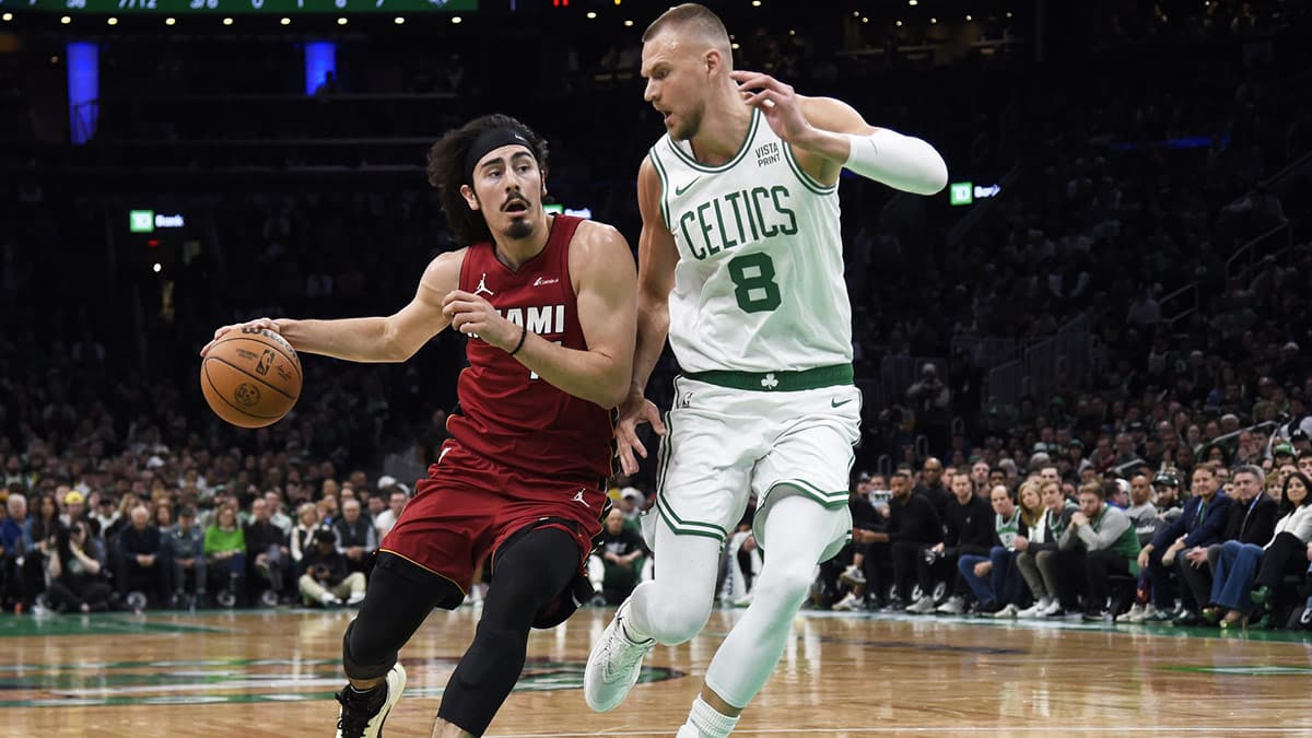 Miami Heat guard Jaime Jaquez Jr. (11) controls the ball while Boston Celtics center Kristaps Porzingis (8) defends during the first half in game one of the first round for the 2024 NBA playoffs at TD Garden.