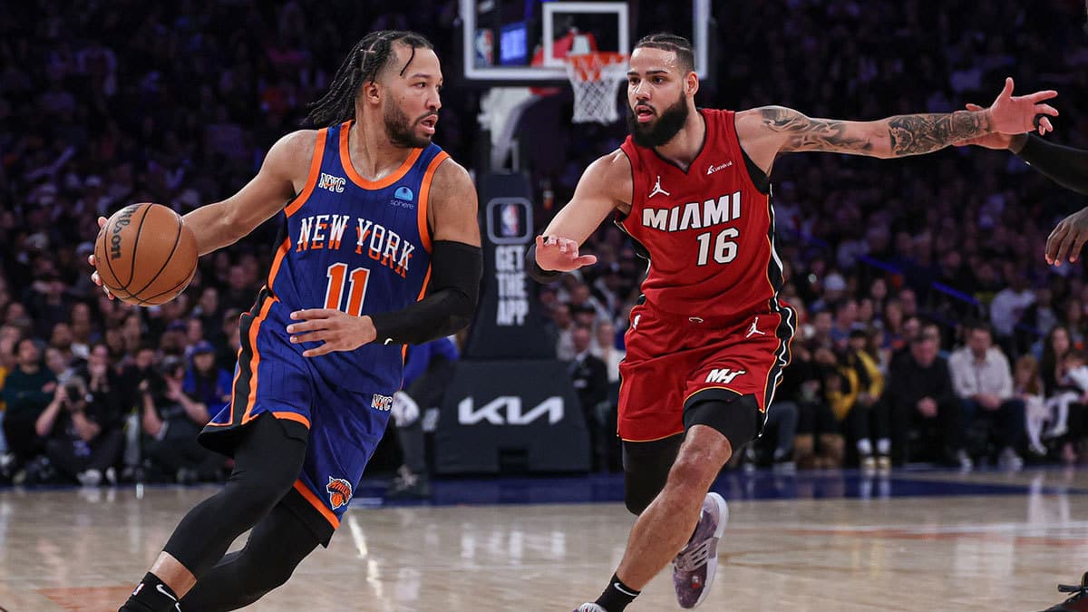 New York Knicks guard Jalen Brunson (11) dribbles against Miami Heat forward Caleb Martin (16) during the second half at Madison Square Garden. 