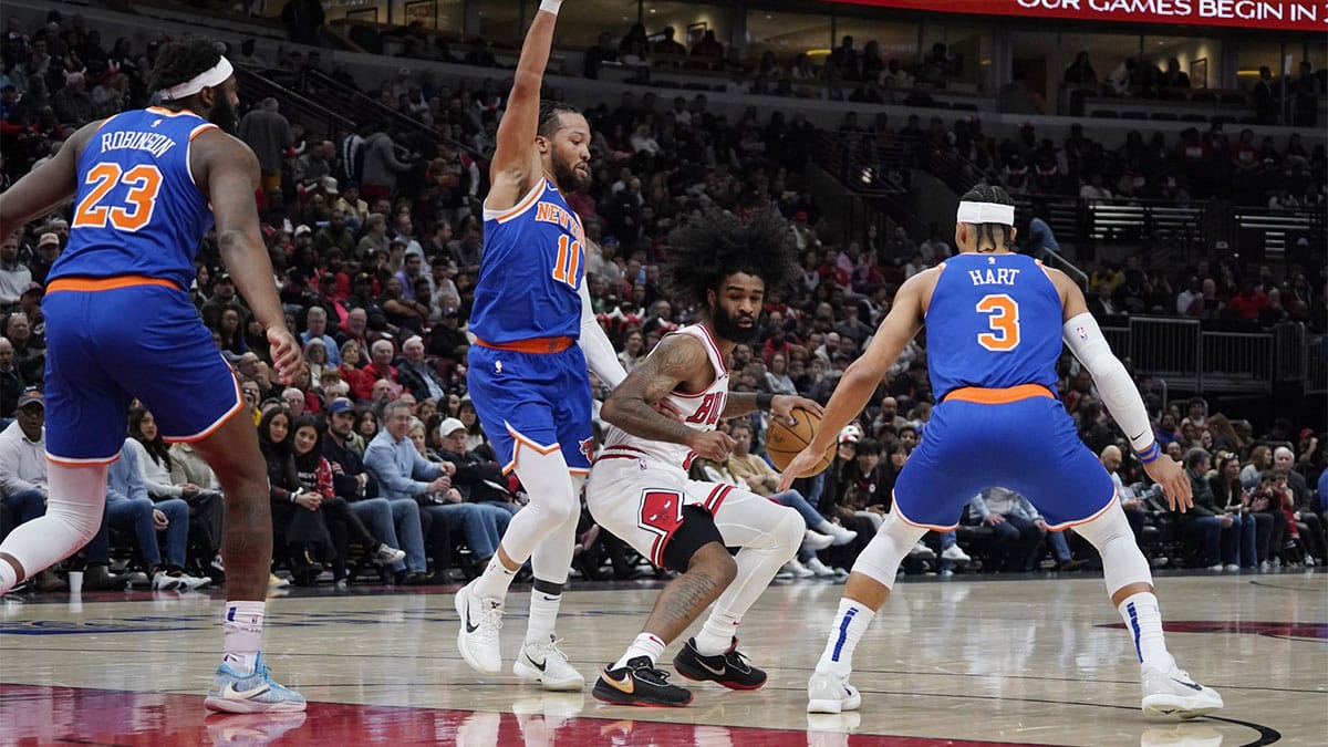 New York Knicks guard Jalen Brunson (11) defends Chicago Bulls guard Coby White (0) during the first quarter at United Center.
