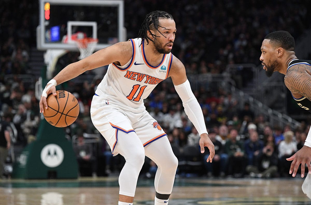 New York Knicks guard Jalen Brunson (11) brings the ball up the court against the Milwaukee Bucks in the second half at Fiserv Forum.