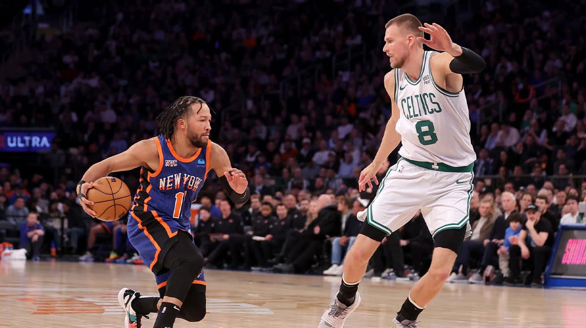 New York Knicks guard Jalen Brunson (11) controls the ball against Boston Celtics center Kristaps Porzingis (8) during the third quarter at Madison Square Garden. 
