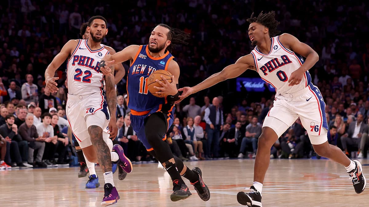 New York Knicks guard Jalen Brunson (11) drives to the basket against Philadelphia 76ers guards Cameron Payne (22) and Tyrese Maxey (0) during the fourth quarter of game 5 of the first round of the 2024 NBA playoffs at Madison Square Garden.