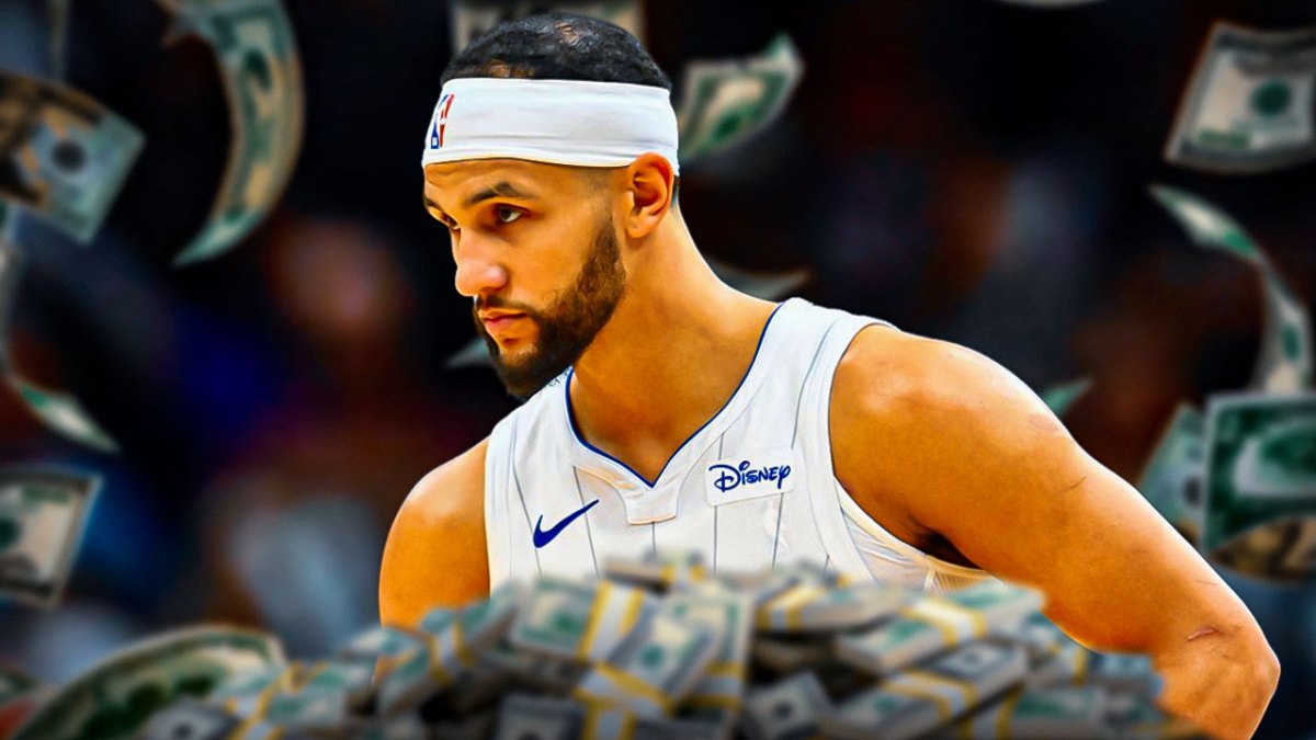 Jalen Suggs surrounded by piles of cash.