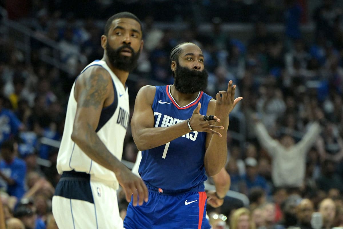 Los Angeles Clippers guard James Harden (1) signals after a 3-point basket over Dallas Mavericks guard Kyrie Irving (11) in the first half at Crypto.com Arena. 