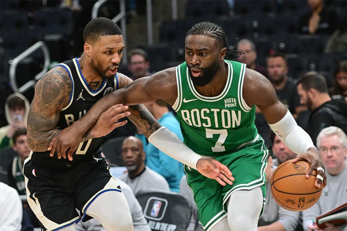 Boston Celtics forward Jaylen Brown (7) drives past Milwaukee Bucks guard Damian Lillard (0) in the third quarter at Fiserv Forum.