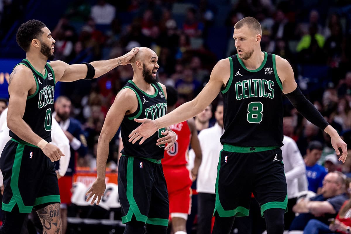 Boston Celtics guard Derrick White (9) reacts with teammates after making a basket against the New Orleans Pelicans during the second half at Smoothie King Center