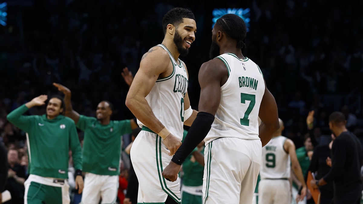 Boston Celtics forward Jayson Tatum (0) and guard Jaylen Brown (7) celebrate during overtime of their 127-120 win over the Minnesota Timberwolves at TD Garden